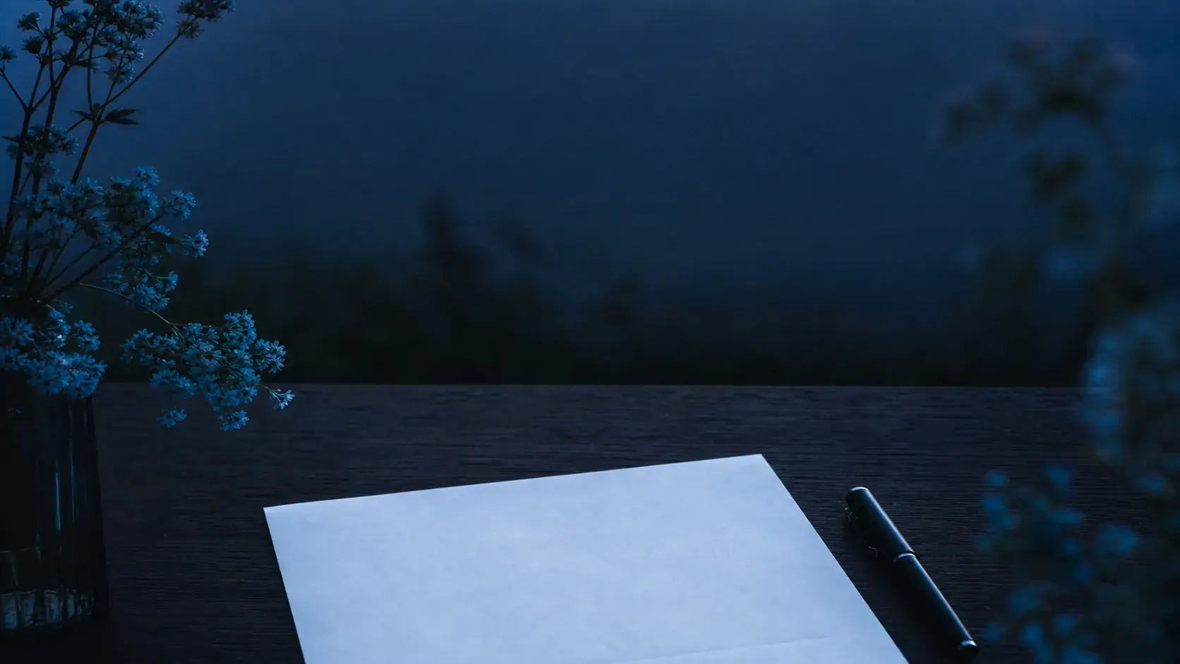 A blank invoice and pen on a blue-hour worktable