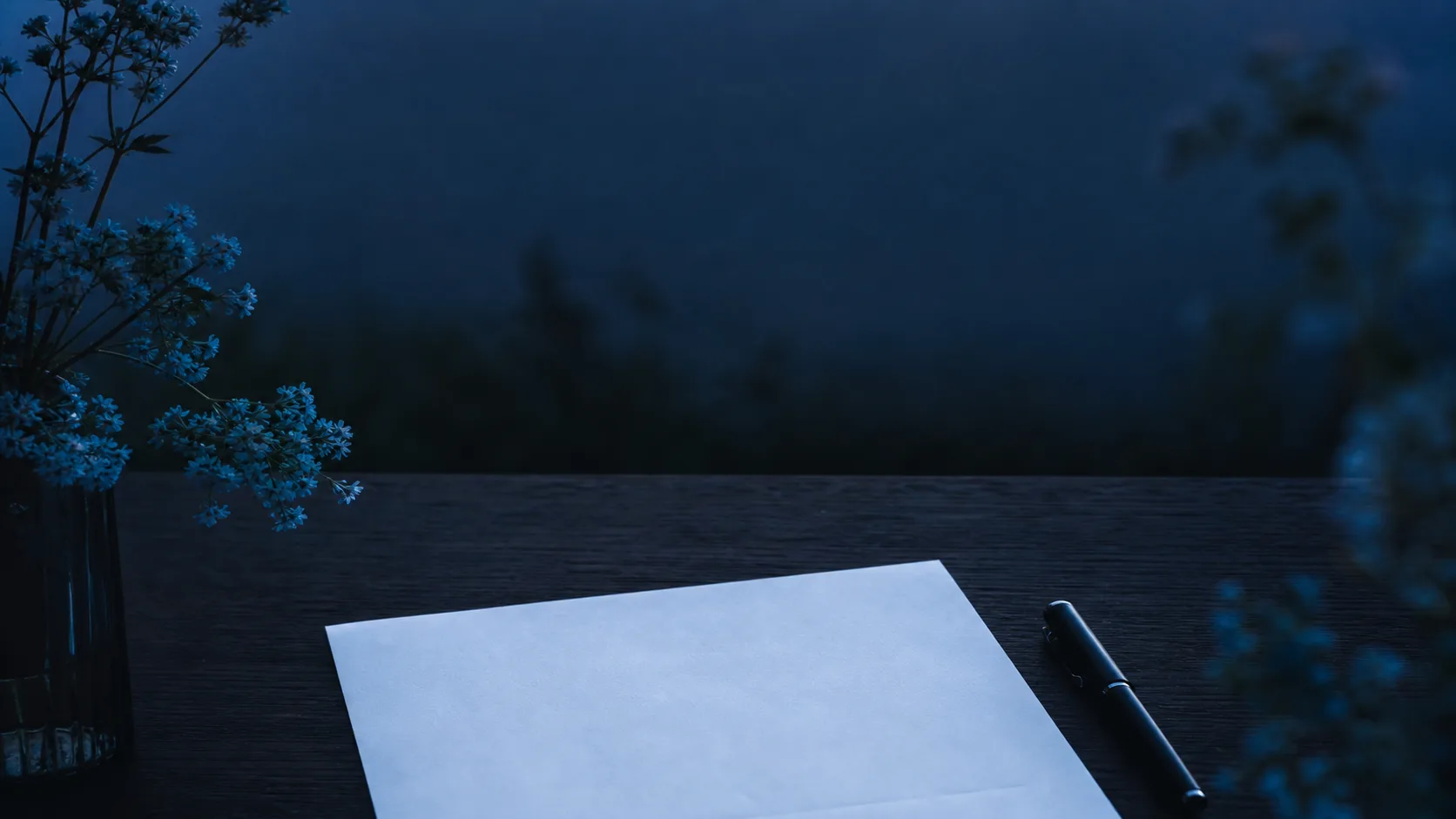 A blank invoice and pen on a blue-hour worktable